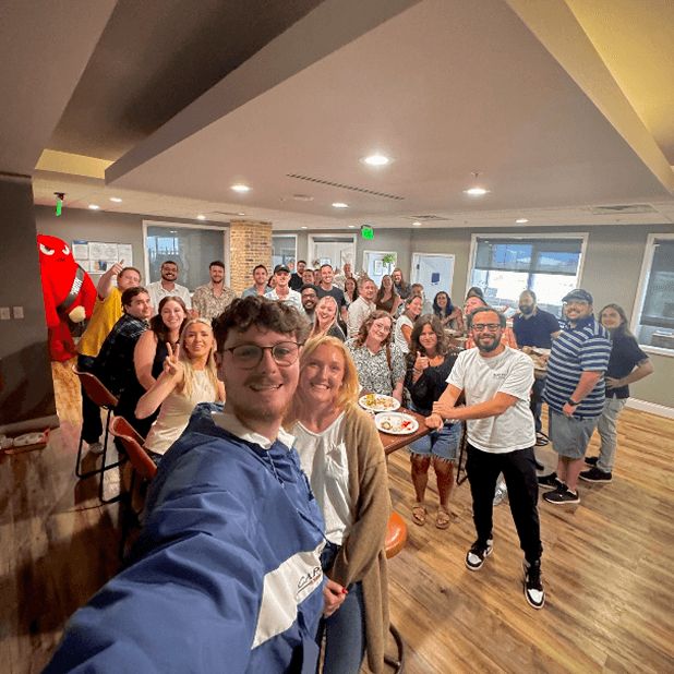 Woman with sunglasses on rooftop overlooking city skyline