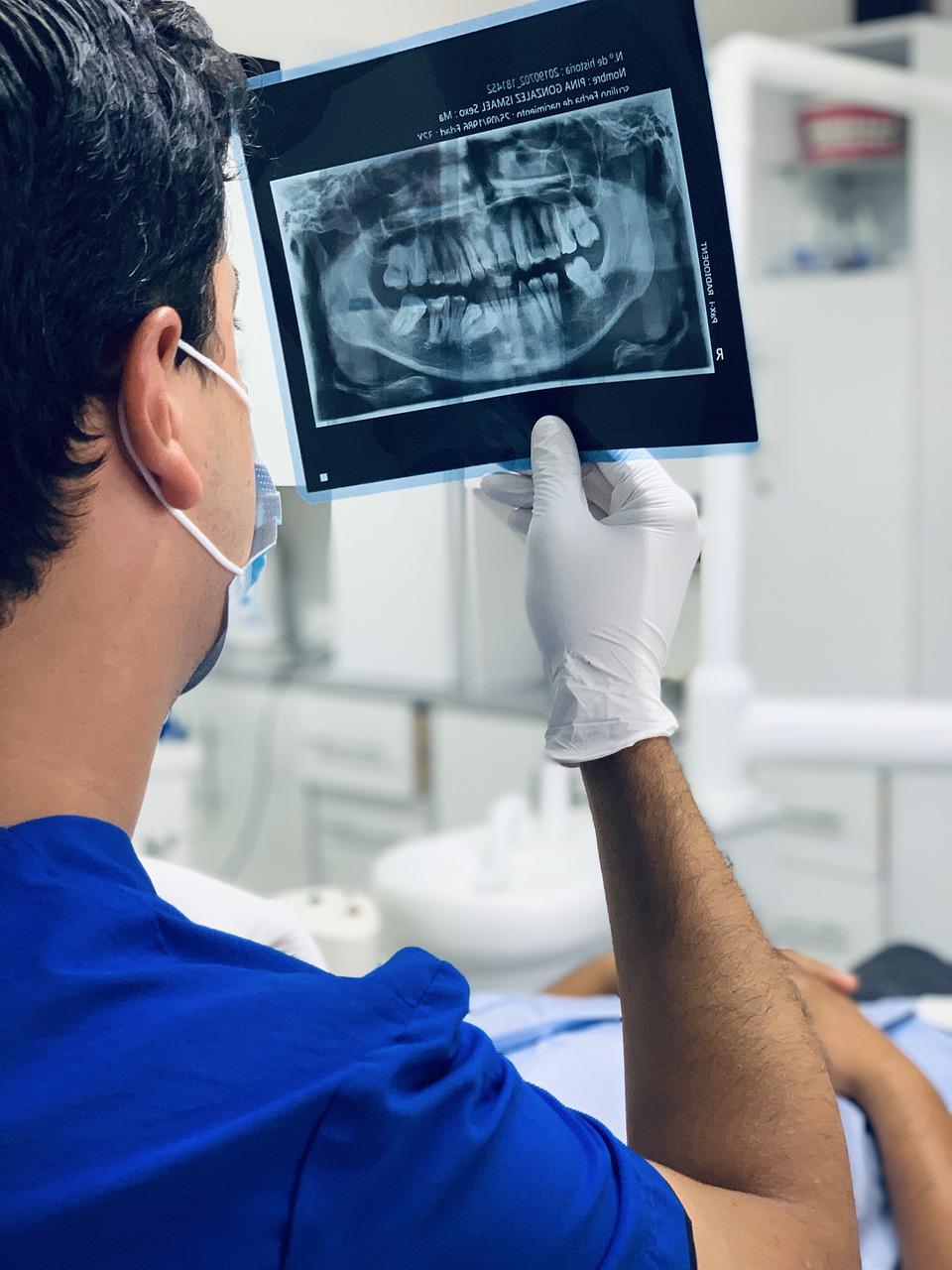 An orthodontist examines a patient's X-rays.