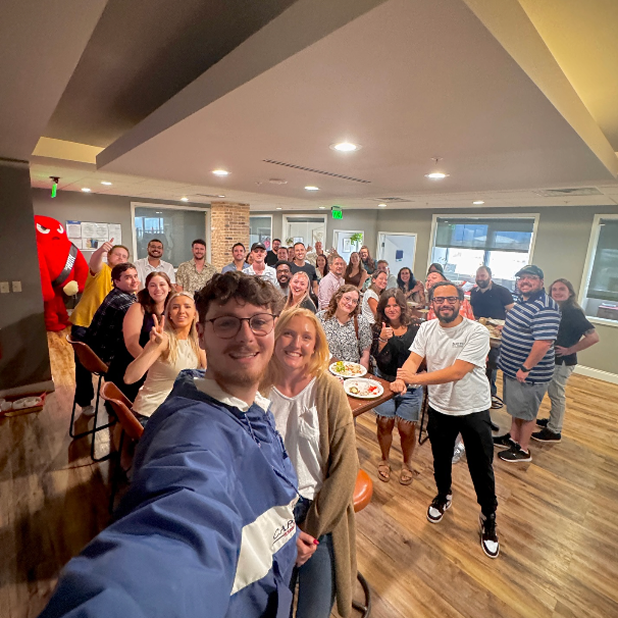 Woman with sunglasses on rooftop overlooking city skyline